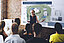 Woman standing in front of colleagues with an outline of a company premises in the background