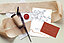 Wedding invitation with a fountain pen laying next to it