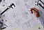 Table with technical drawings and tools for measuring
