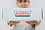 Woman holding Krispy Kreme donut wrapper into the camera