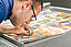 Man reads newspaper with magnifying glass
