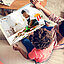 Two children looking at a photo album of them