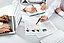 Employees sitting at the table with analysis data in the middle